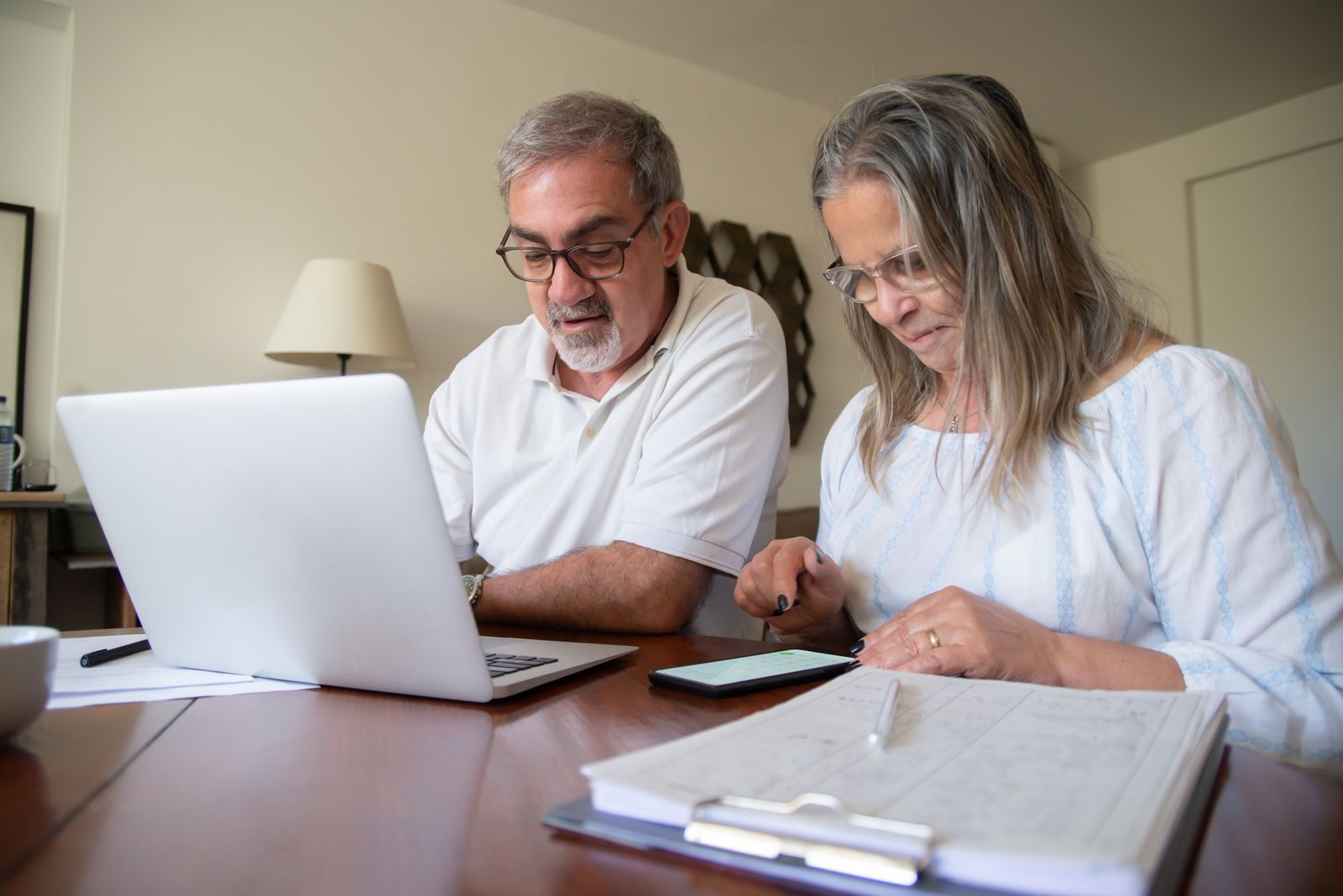 Couple reviewing travel plans on a laptop